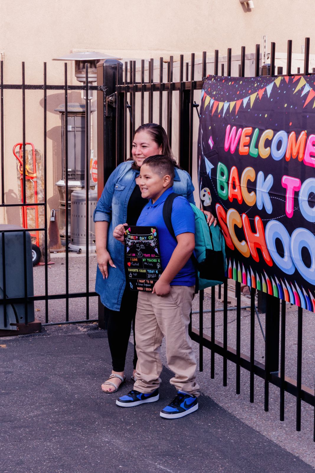 Mother and son arriving at the Back to School welcome sign