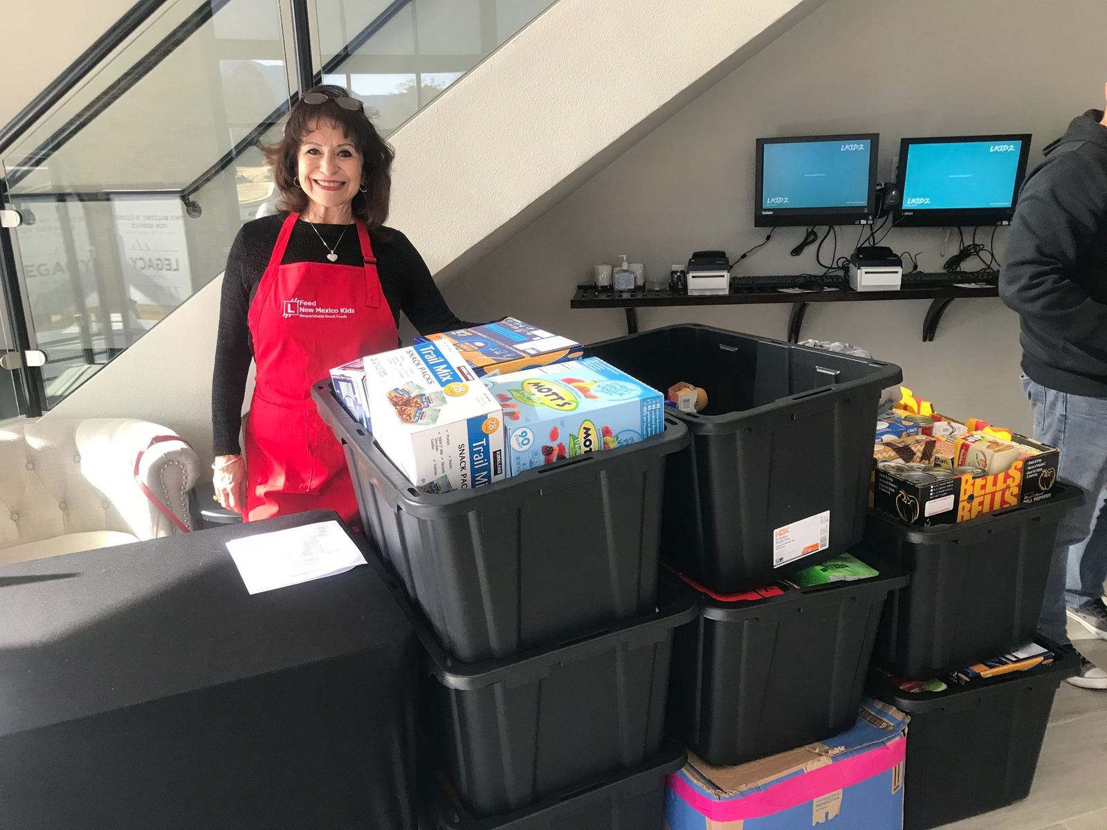 Feed New Mexico Kids volunteer packing food boxes for students