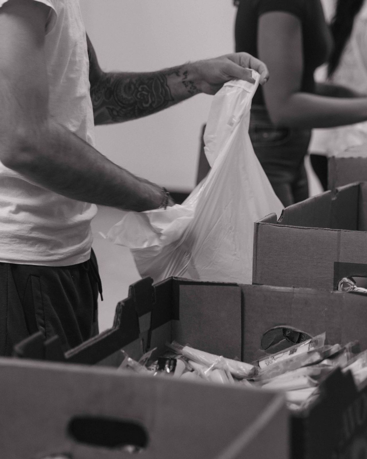 Volunteer packing donations for neighbors in need