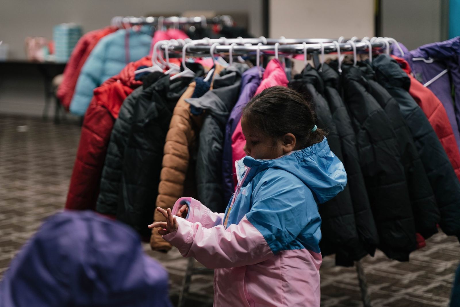 Child choosing a donated winter coat