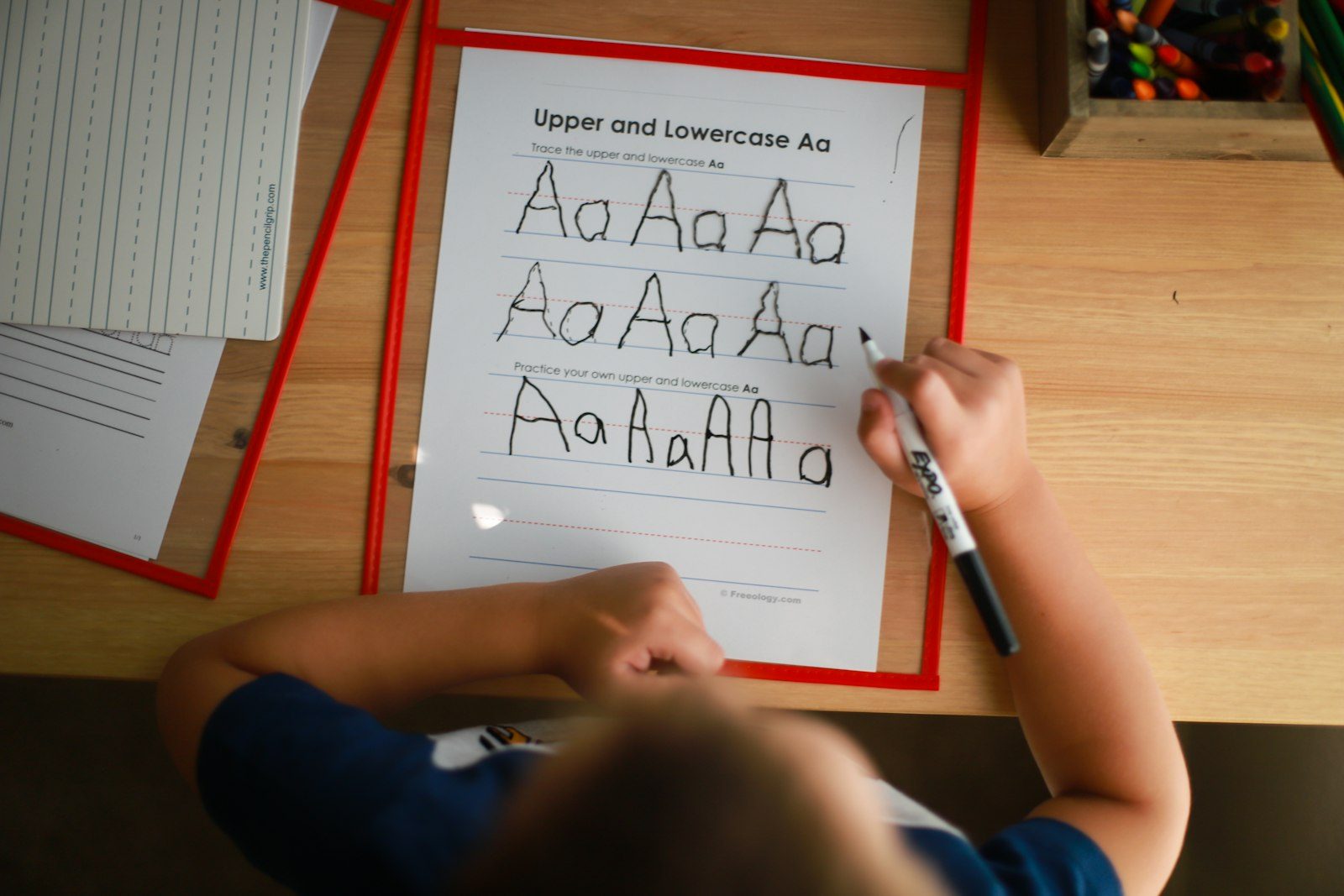Young student practicing handwriting at a desk